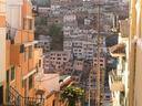 Steep streets and hill beyond.